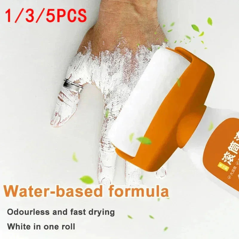 Hand applying white water-based paint with an orange roller, fast drying, odourless formula.