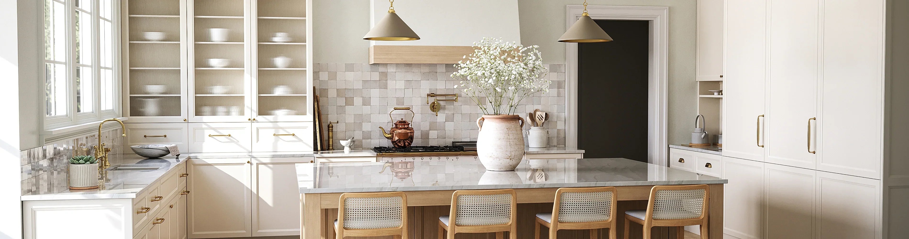Modern kitchen with white cabinets, marble countertop, gold fixtures, and large island