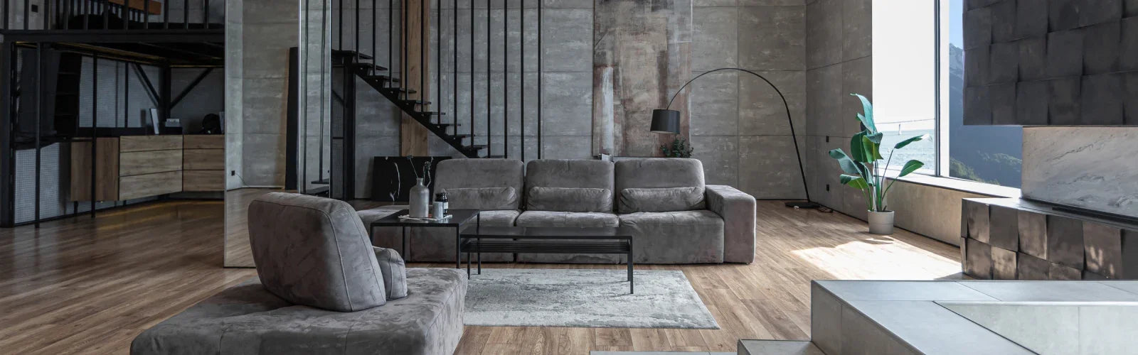 Modern living room with grey sofa, minimalist decor, indoor plant, large windows and wooden floor