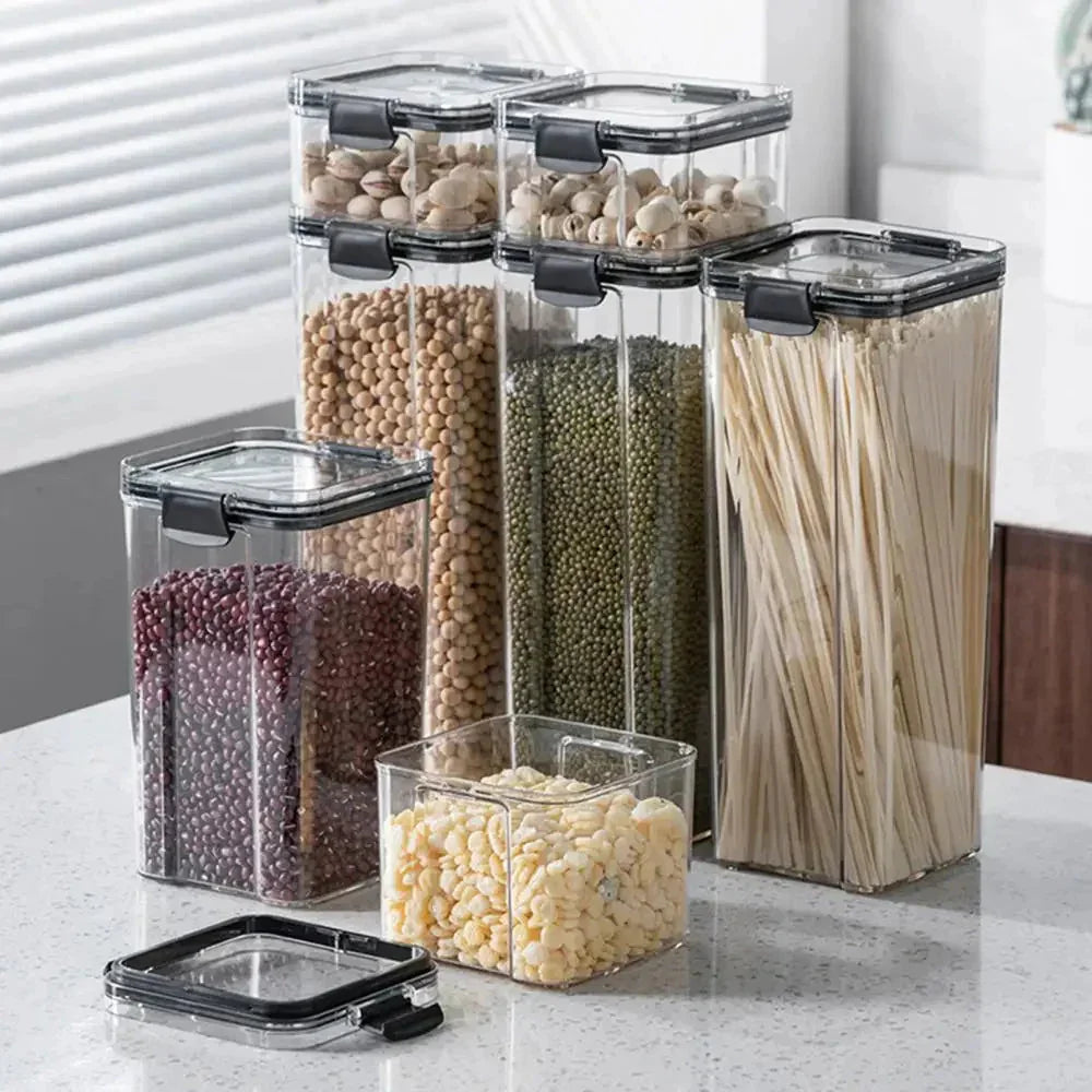 Clear airtight kitchen storage containers with assorted dry foods on a countertop